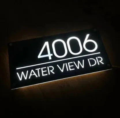 Custom LED house address sign displaying number 4006 and WATER VIEW DR glowing on black acrylic plaque