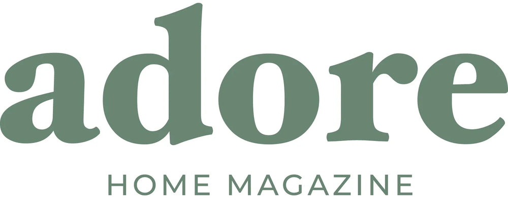 Logo of 'adore Home Magazine' with green text on a white background